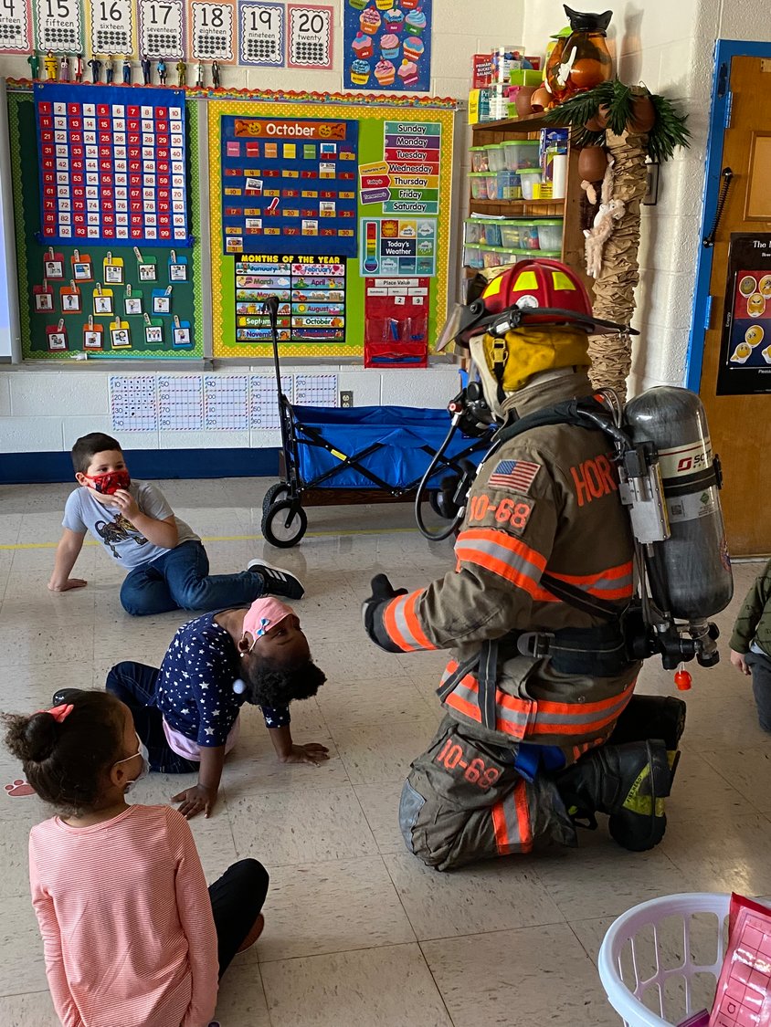 Deputy Michael Barrett, school resource officer at the Cooke School, teaches kids fire safety.